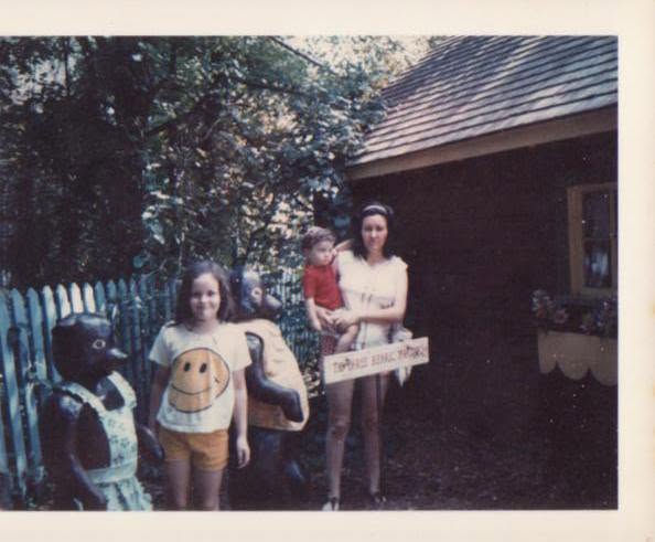 A vintage photograph of the founder as a young child with his mother and older sister.